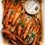 Crispy sweet potato fries with Parmesan and herbs, served with a dip.