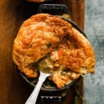 Golden-brown mushroom pot pie with flaky crust in a cast-iron dish.