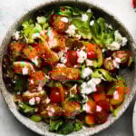 Fresh salad with crispy buffalo chicken, cherry tomatoes, carrots, and yogurt ranch dressing.