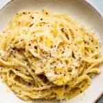 Creamy lemon mascarpone pasta topped with black pepper in a white bowl.