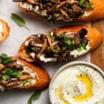 Toasts with mushrooms, whipped goat cheese, herbs, and a dish of creamy spread.