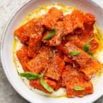 Rigatoni in creamy vodka sauce with whipped ricotta and fresh basil leaves.