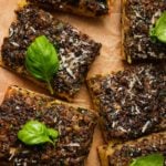 Sliced mushroom roasted garlic bread topped with fresh basil and grated cheese.