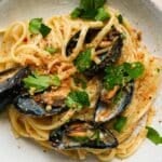 Linguine with mussels, parsley, and breadcrumbs in a creamy white wine sauce.