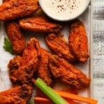 Spicy baked buffalo wings with celery, carrots, and dipping sauce.