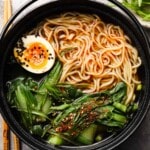 Bowl of vegetarian shoyu ramen with noodles, bok choy, and half a boiled egg.