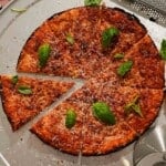 Bar-style pizza cut into slices ready to eat.