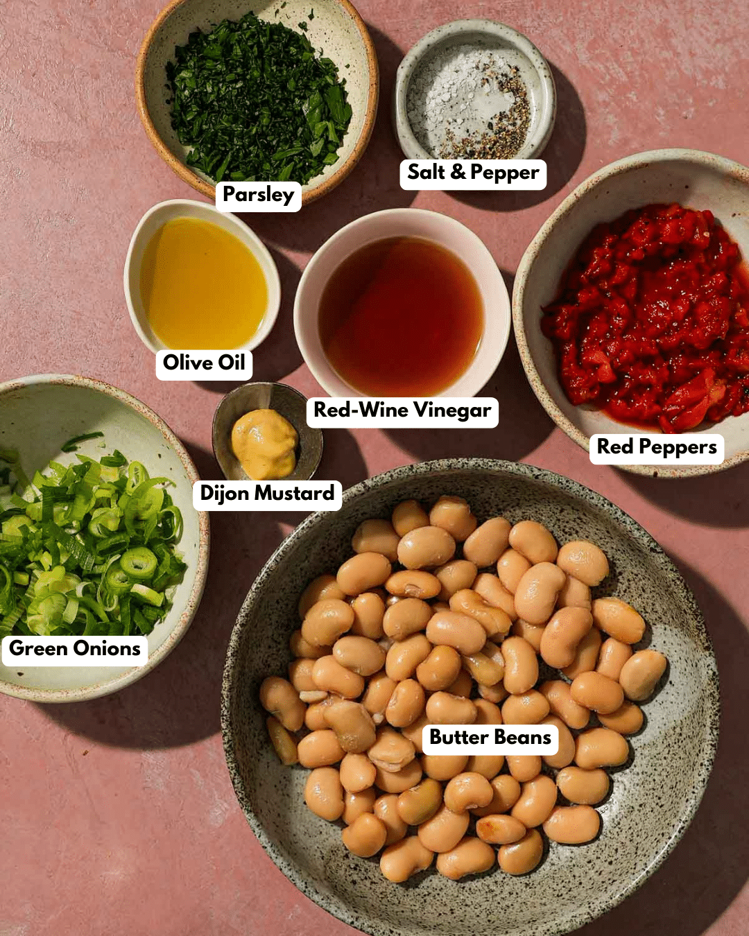 Ingredients for bean salad including beans, parsley, peppers, scallions, mustard, and dressing.