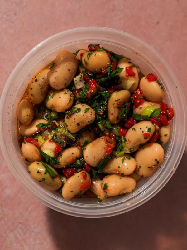 Bean salad mixed with parsley, peppers, and scallions coated in vinaigrette.