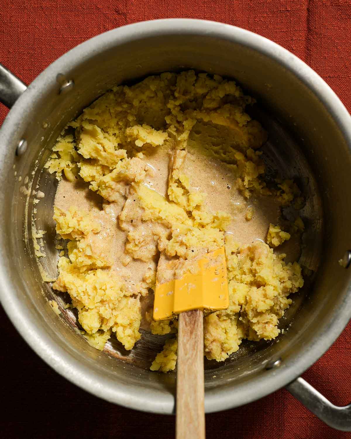 A pot of mashed potatoes about to be tossed with infused heavy cream.