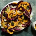 A platter of delicata squash salad with fennel, radicchio, and dressing.