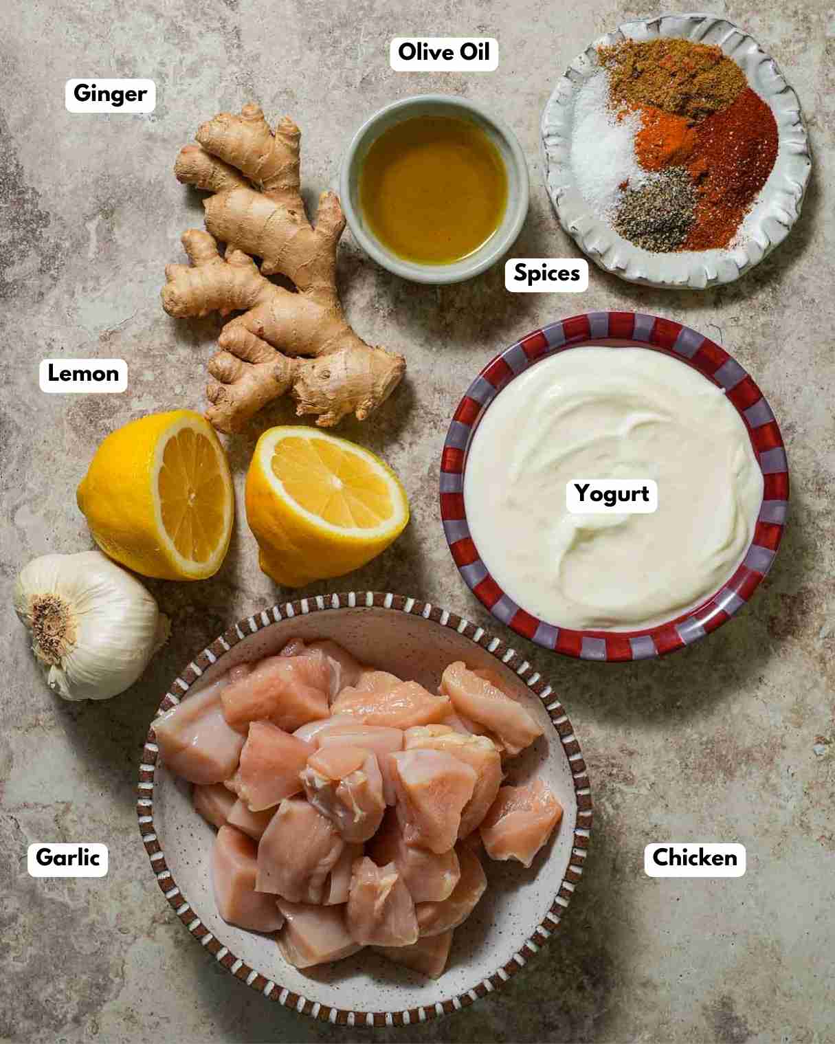 The ingredients laid out to make marinated chicken skewers with Greek yogurt.