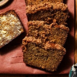 Slices of brown butter banana bread on a cutting board with butter.