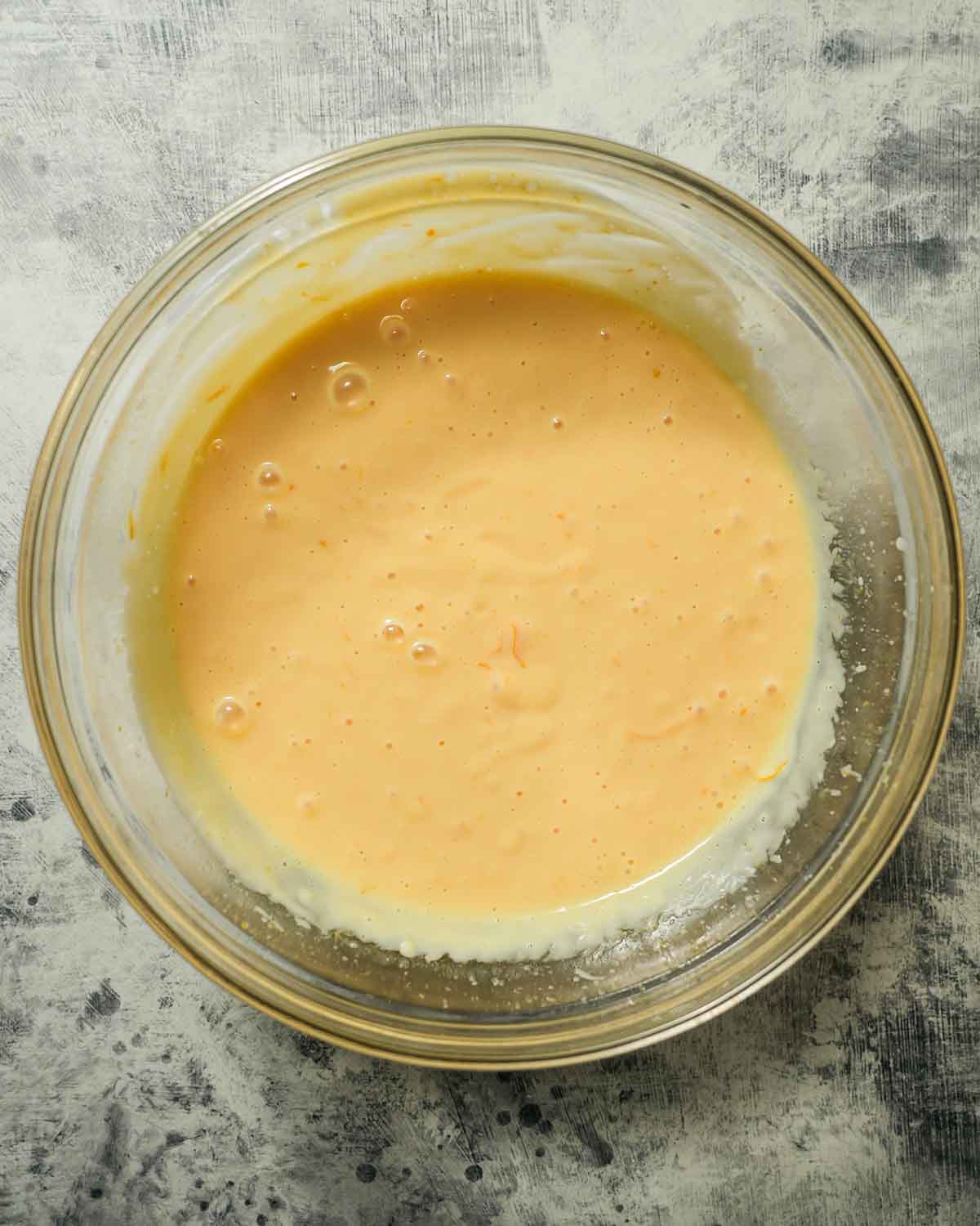 A glass bowl with meyer lemon pie filling.
