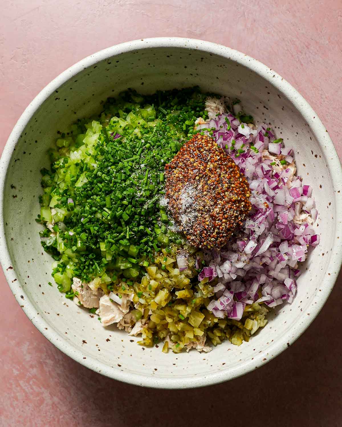 A big bowl of all the ingredients to make dill pickle chicken salad, ready to be mixed together.