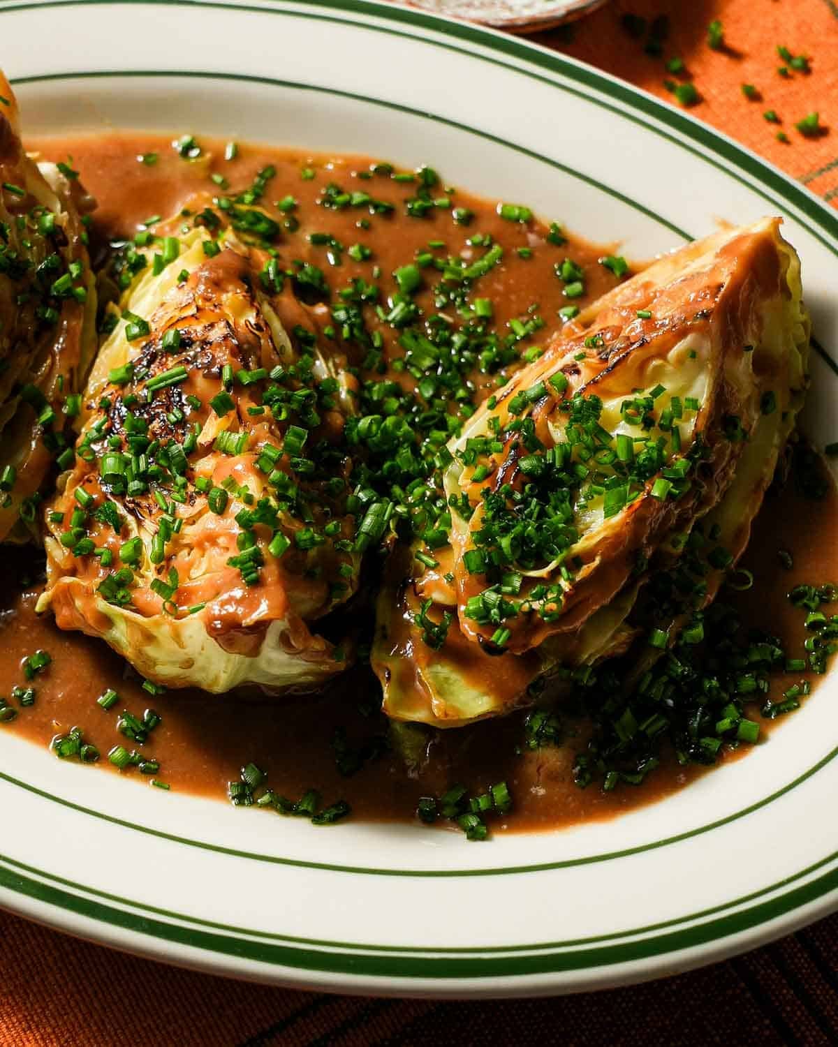 A platter of braised cabbage with miso sauce and finished with freshly cut chives.