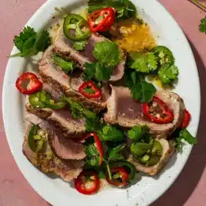 A platter of seared ahi tuna with peppercorns and a yuzu dressing.