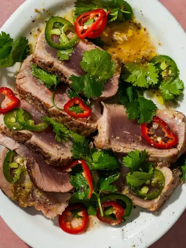 A platter of seared ahi tuna with peppercorns and a yuzu dressing.