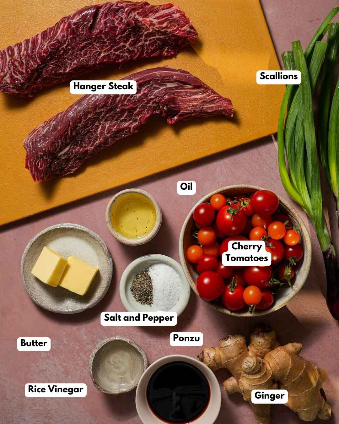 Ingredients laid out on a cutting board to make hanger steak with tomatoes and ginger scallion ponzu sauce.