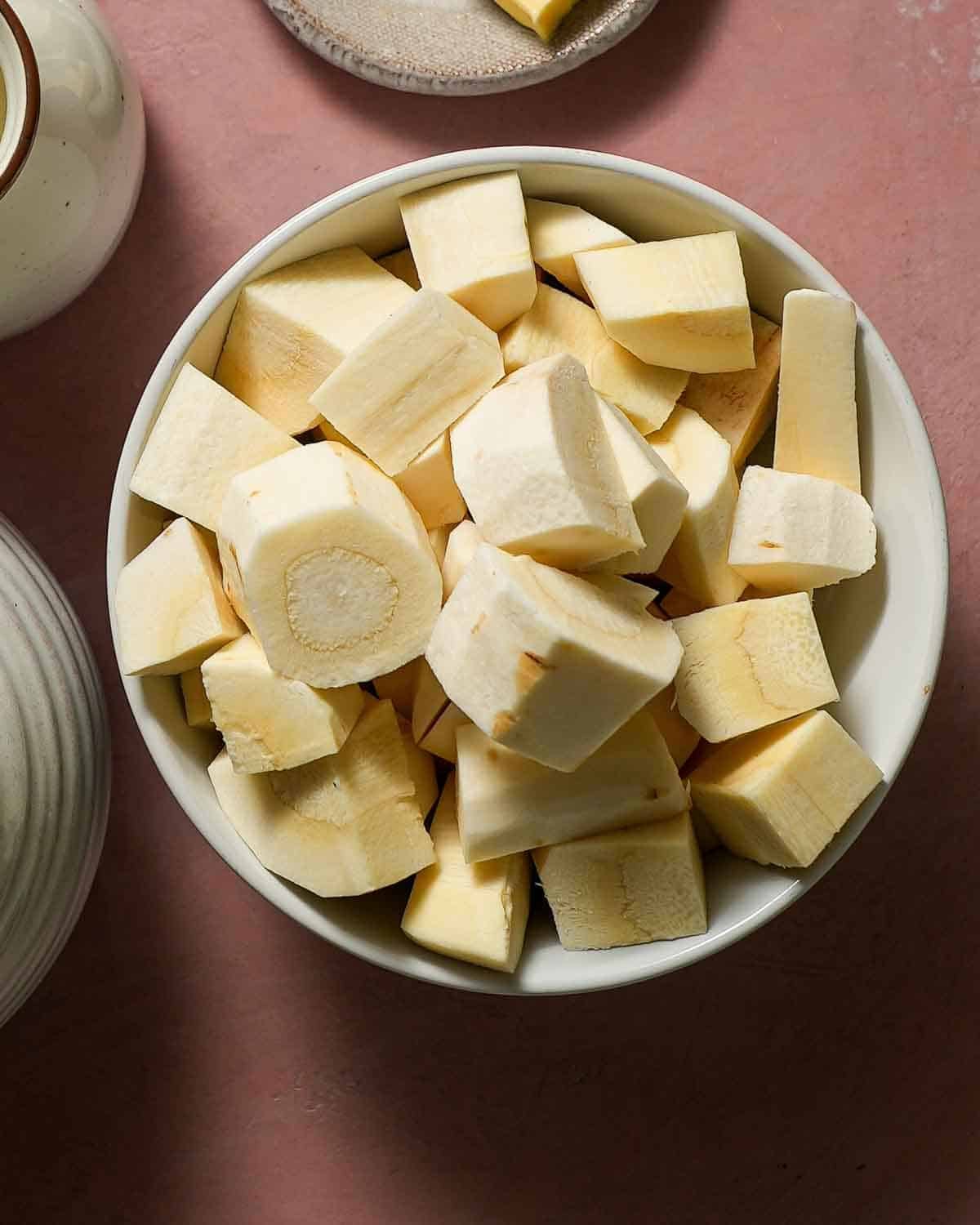 A bowl of cubed and peeled parsnips.