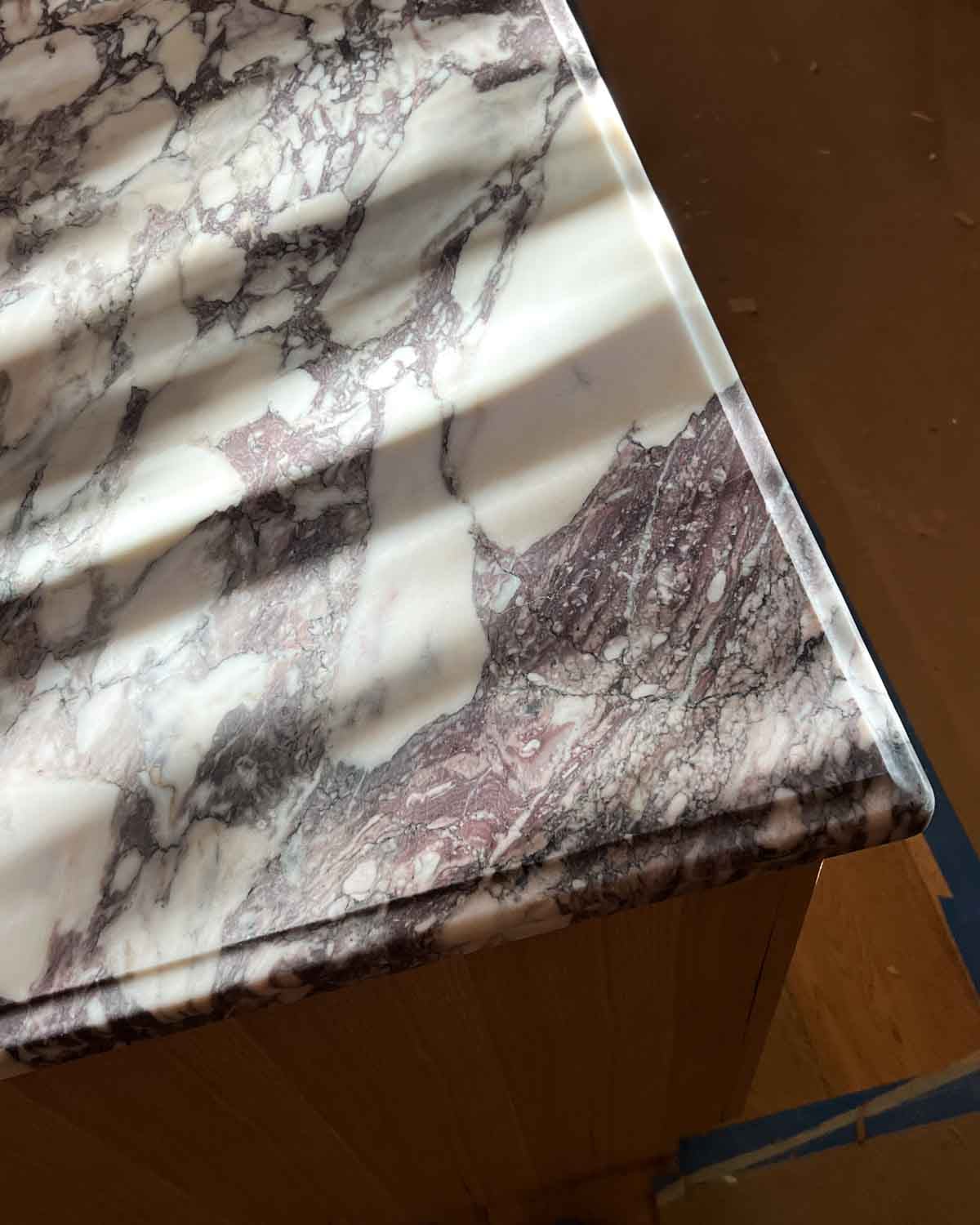 A marble countertop with sun peeking on it.