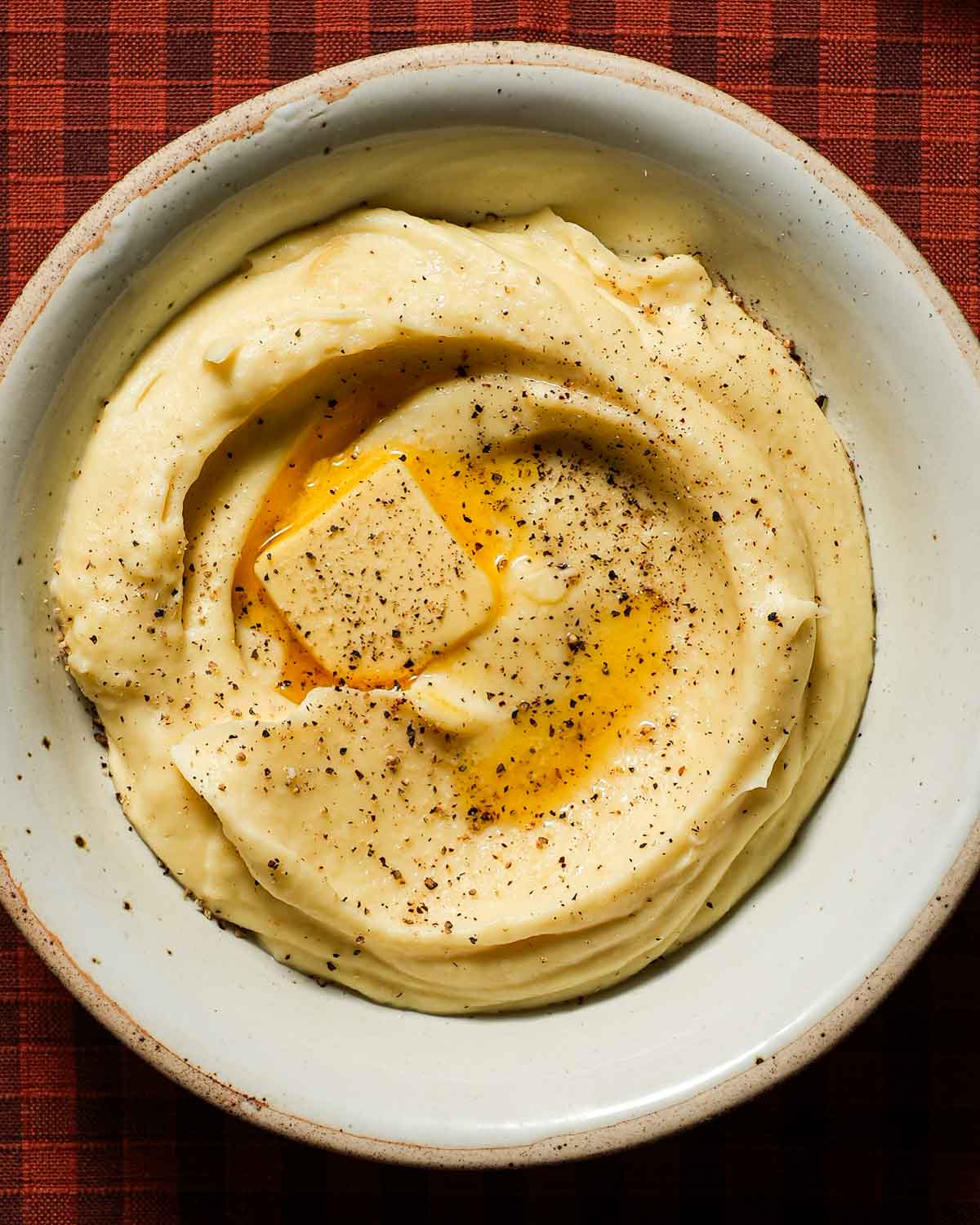 A creamy bowl of parsnip puree with a melted knob of butter.