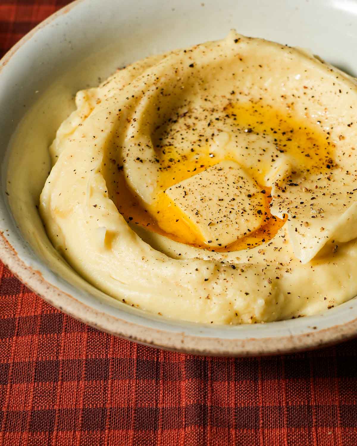 A creamy bowl of parsnip puree with a melted knob of butter.