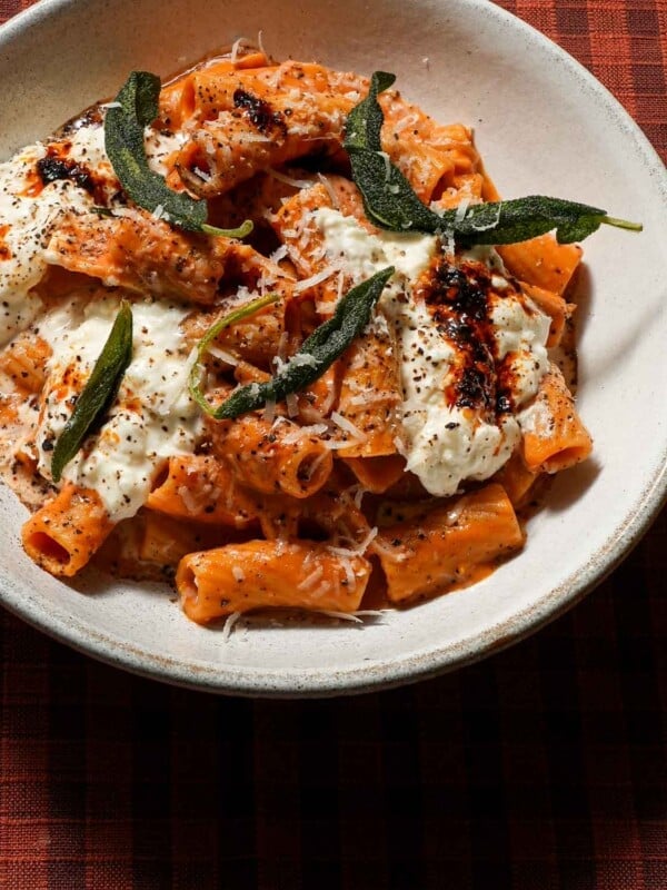 A bowl of chili crisp pumpkin rigatoni with sage.