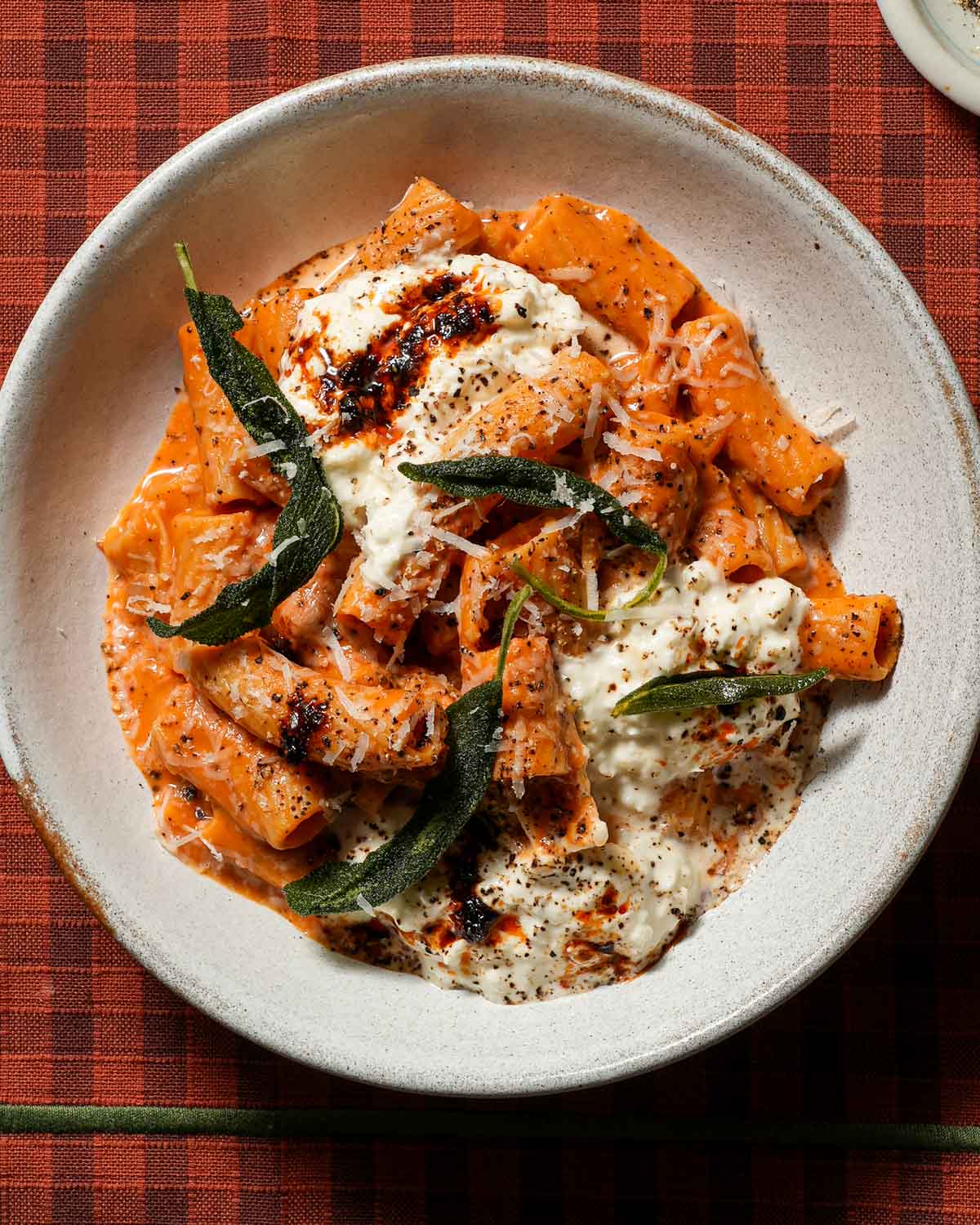 A bowl of pumpkin rigatoni with crispy sage and stracciatella.